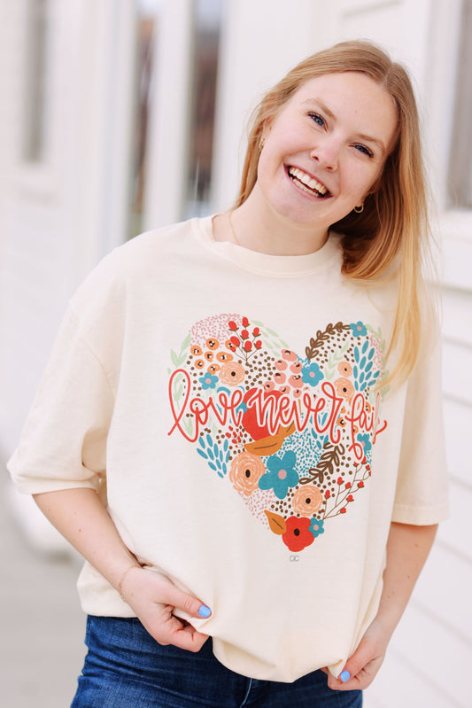Love Never Fails Graphic Tee (S-3X)